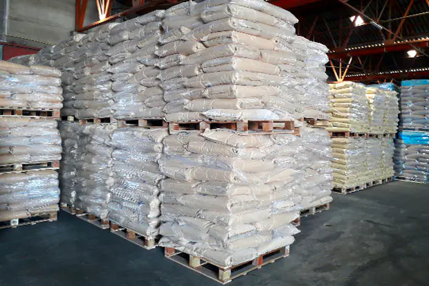 In einem Lagerraum stehen mehrere Paletten mit  Ware, die bis zur Decke gestalpelt ist.